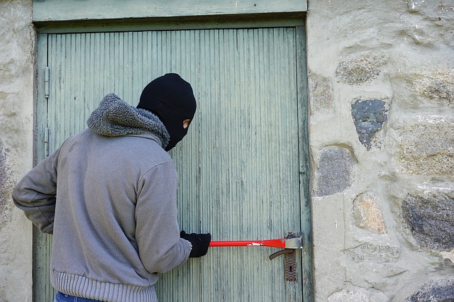 image of man breaking into house