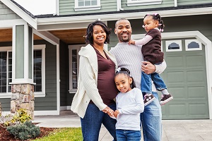 family standing outside home