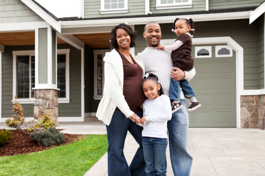 family in front of house